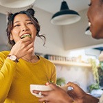 Group of friends smiling while enjoying meal together