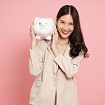 Woman holding a piggy bank and smiling