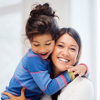 Smiling mother and child after family dentistry appointment