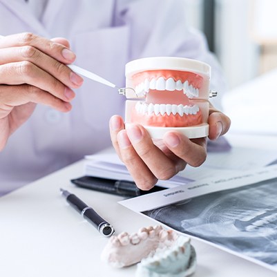 Dentist pointing to smile model