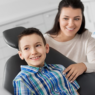 Preteen boy smiling after silver diamine fluoride treatment