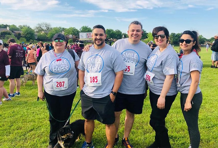 Five team members at community run event