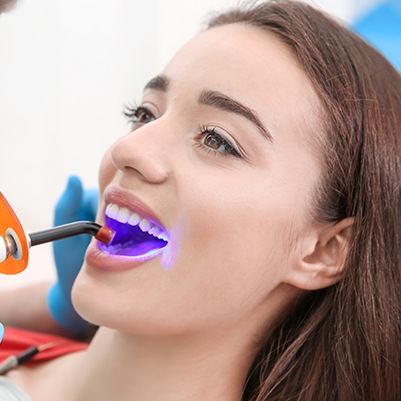 Female patient receiving dental bonding treatment