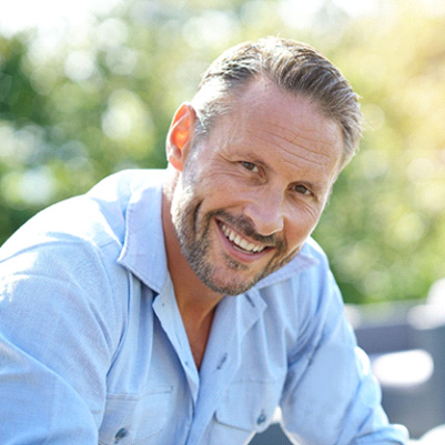 man smiling with dental crowns in Frisco