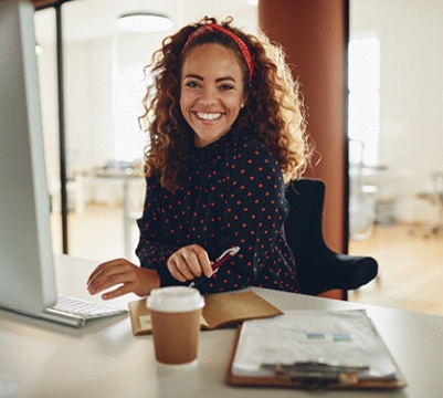 Woman with dental bonding in Frisco smiling in office