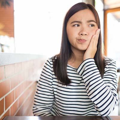 Woman with questions for her emergency dentist in Carrollton