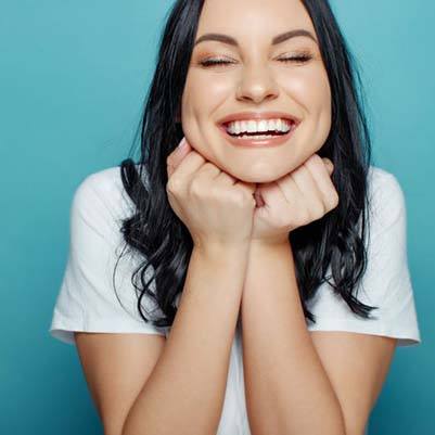 Happy, healthy woman smiling after toothache treatment in Carrollton 