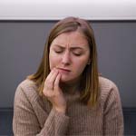 Woman with toothache at emergency dentist