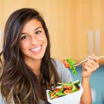 Woman eating salad in Frisco