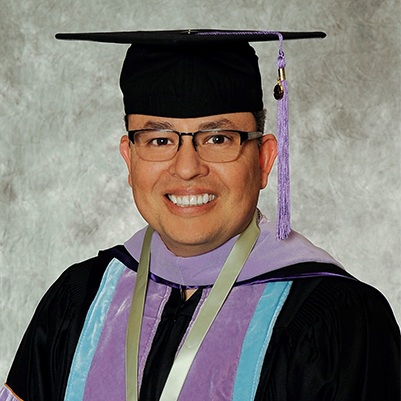 Dr. Caballero in his graduation cap and gown