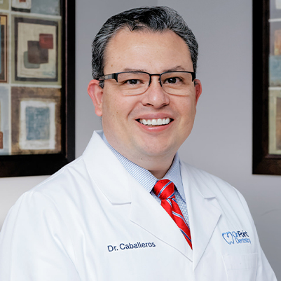 Dr. Caballeros smiling in dental office