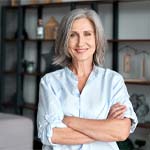 Older woman smiling with arms crossed