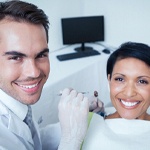 Patient smiling with an implant dentist in Frisco