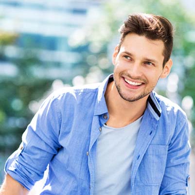 Man in blue jacket with dental implants in Frisco, TX
