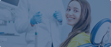 Young woman in yellow blouse smiling in dental chair