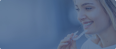 Young woman holding a clear aligner tray