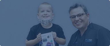 Frisco dentist with young boy wearing face mask