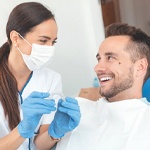 Patient and dentist discussing cost of Invisalign in Frisco