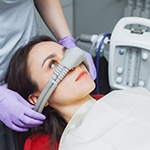 A woman wearing a nose mas while closing her eyes
