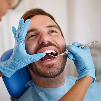 Man receiving oral cancer screening