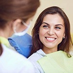 a patient smiling about the cost of root canal therapy