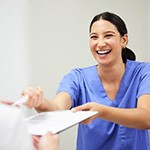 a front desk person discussing the cost of root canals