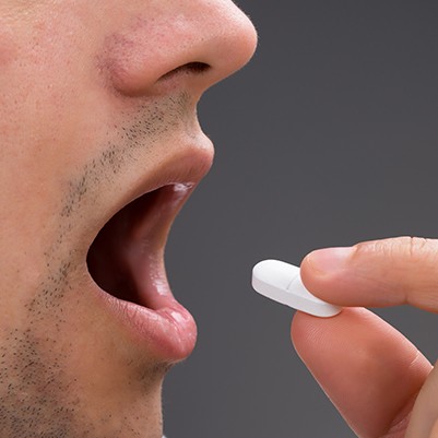 Patient taking oral conscious sedation dentistry pill