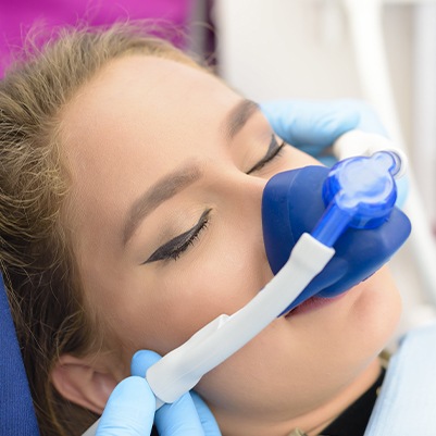 Female patient with nitrous oxide dental sedation mask in place