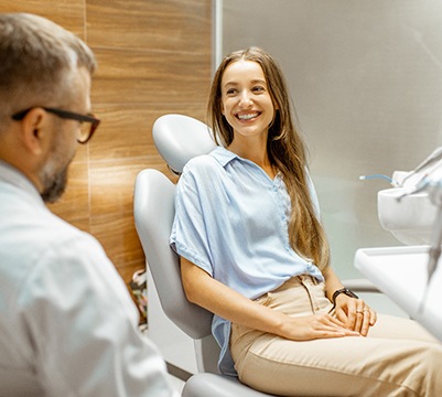 Patient smiling while talking to cosmetic dentist