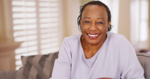 Smiling woman knowing how long do dental implants last