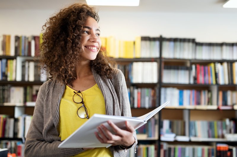 Invisalign teen smiling in library