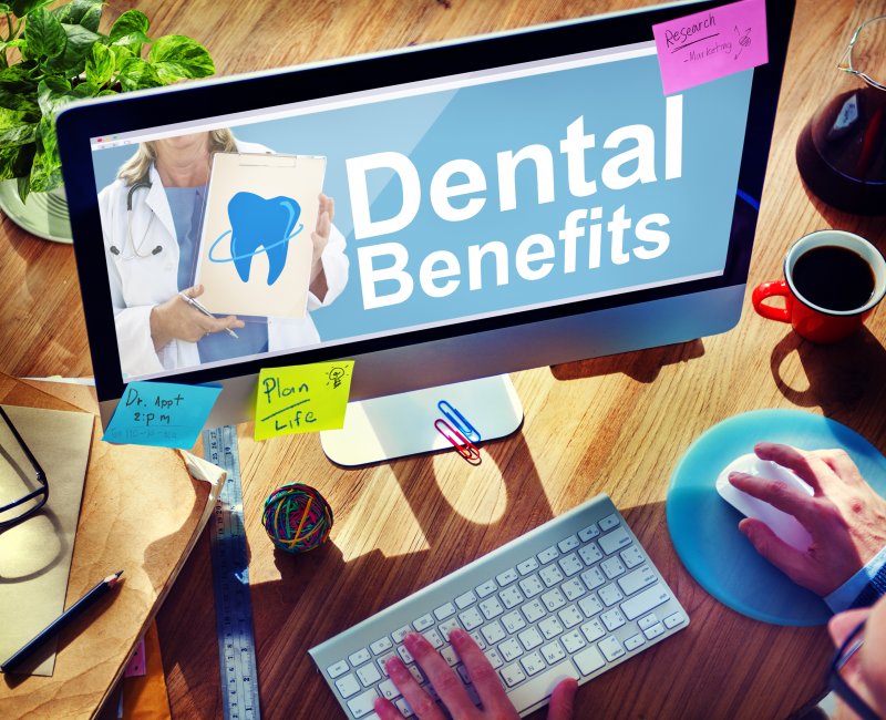 Person using computer to maximize dental insurance benefits