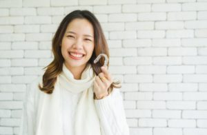 a woman holding her aligners during the holidays