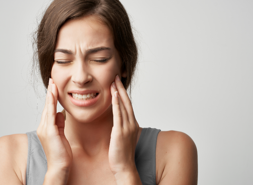 Woman holding face in pain