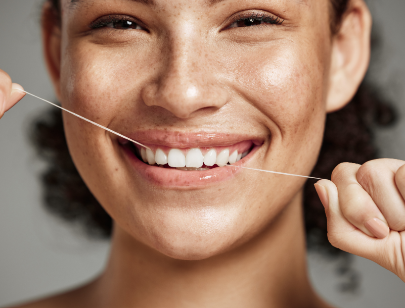 Woman flossing teeth